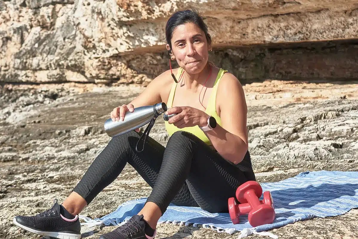 Woman resting after outdoor workout.