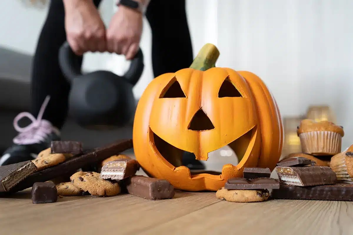 Halloween candy and kettlebell; healthy vs. unhealthy choices.