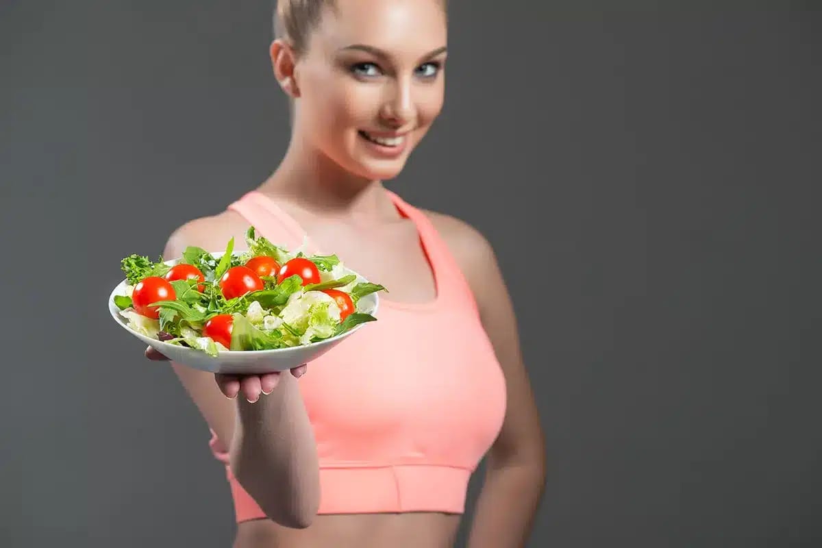 Woman holding healthy salad.