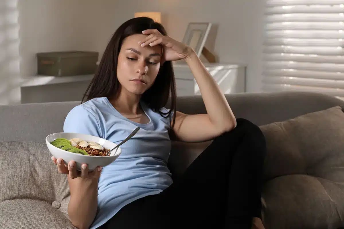 Woman feeling unhappy about her meal.