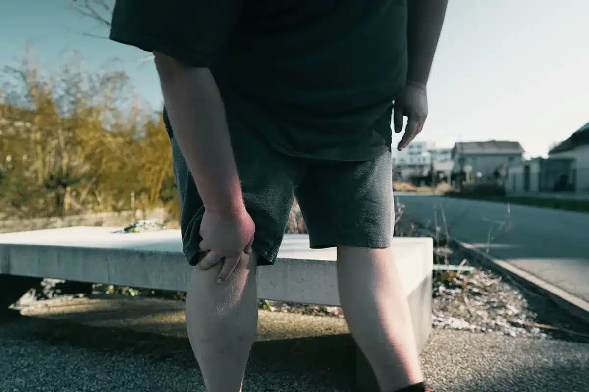 Man touching his knee in pain.