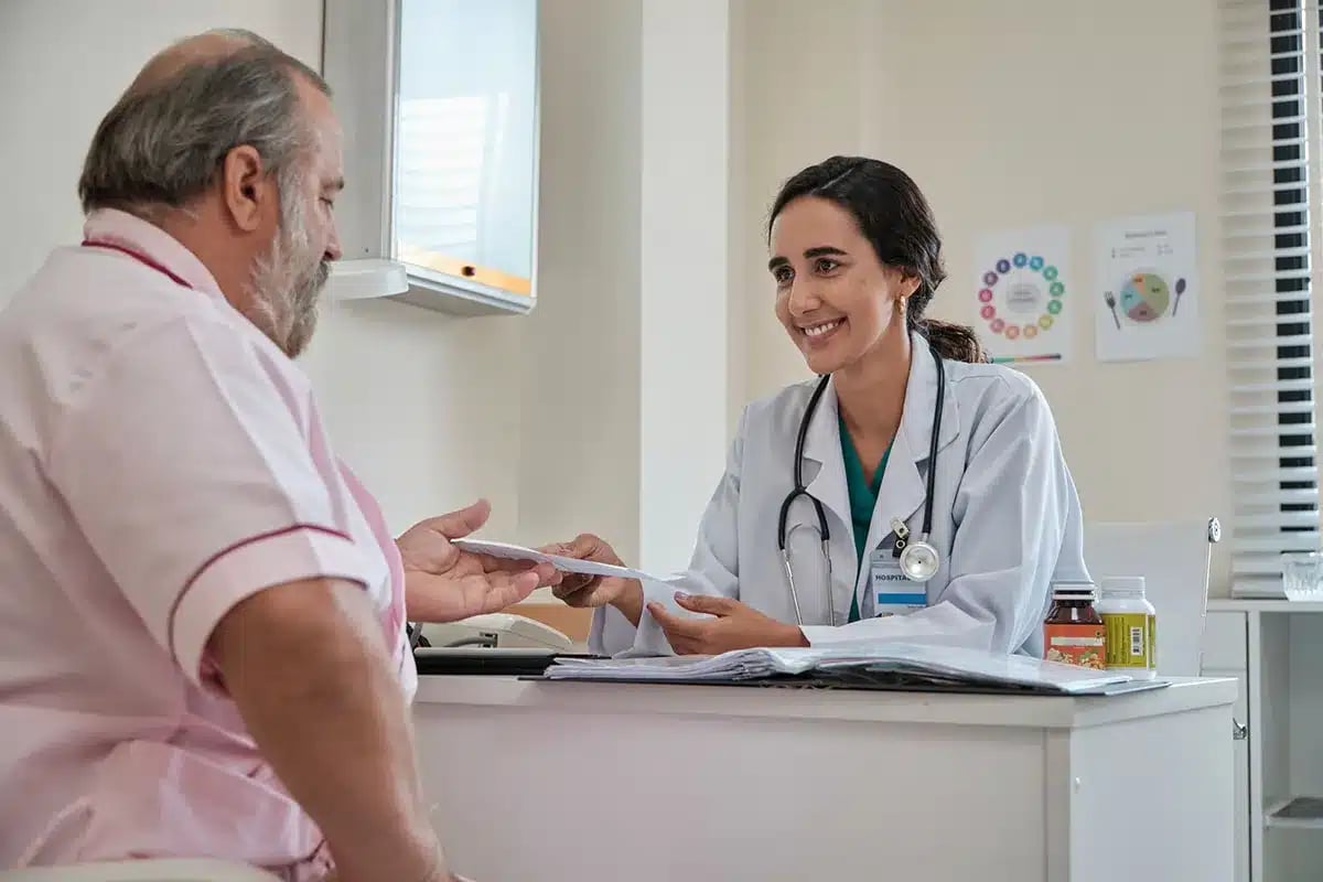 Doctor giving patient a prescription.