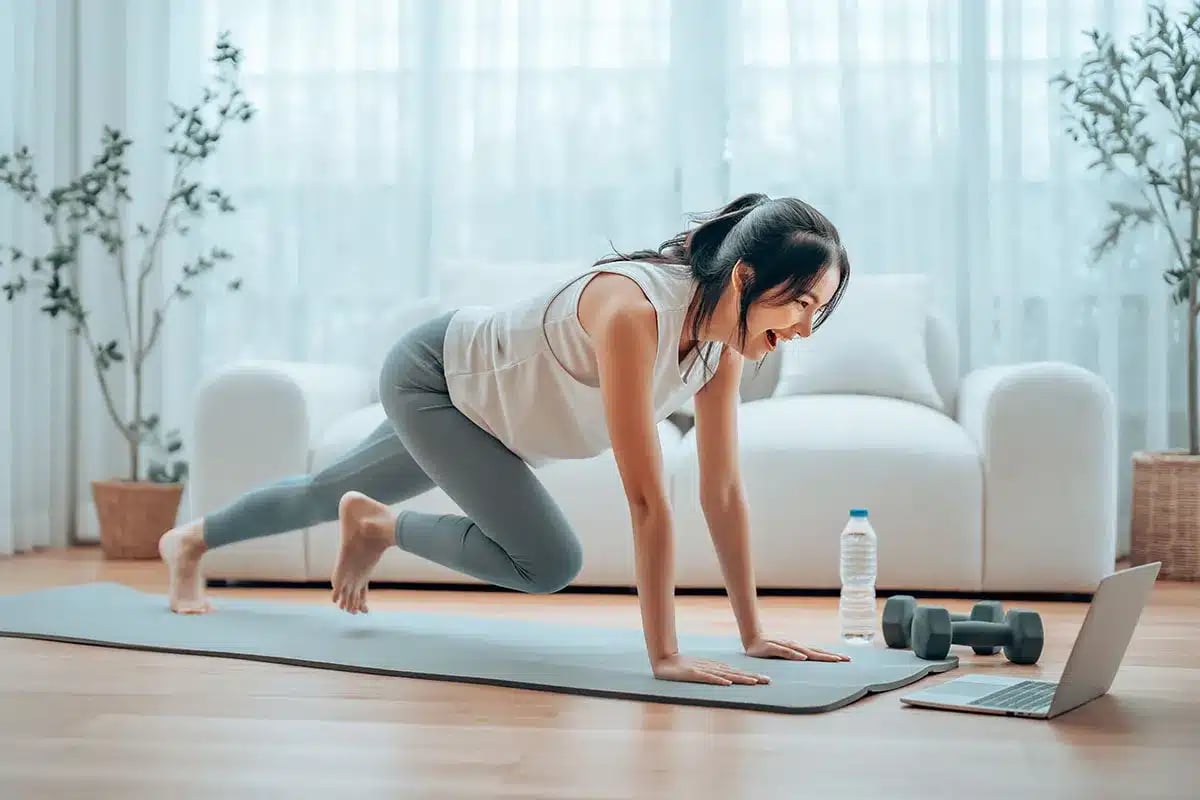 young asian woman doing sport exercises indoor