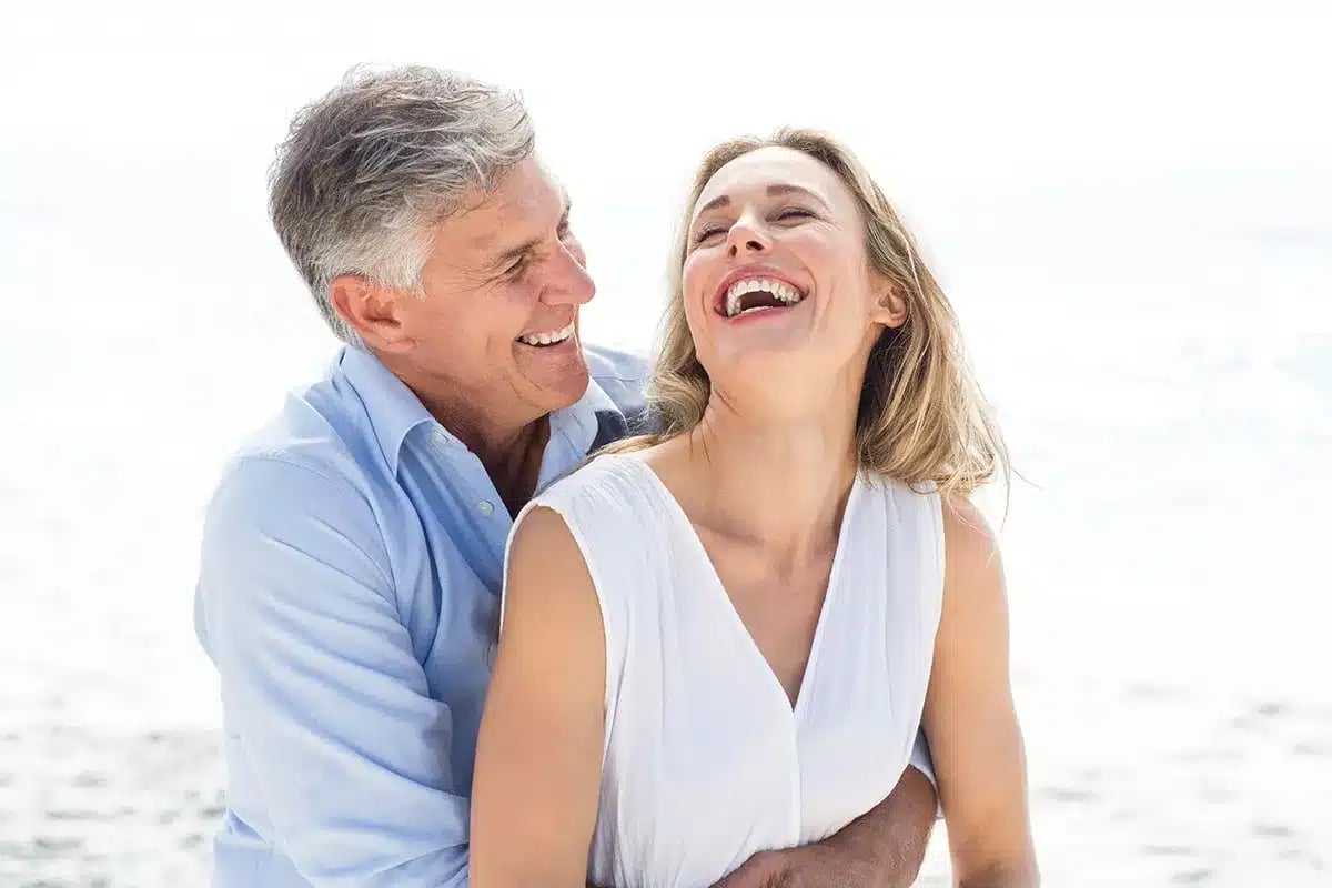 Happy mature couple embracing outdoors.