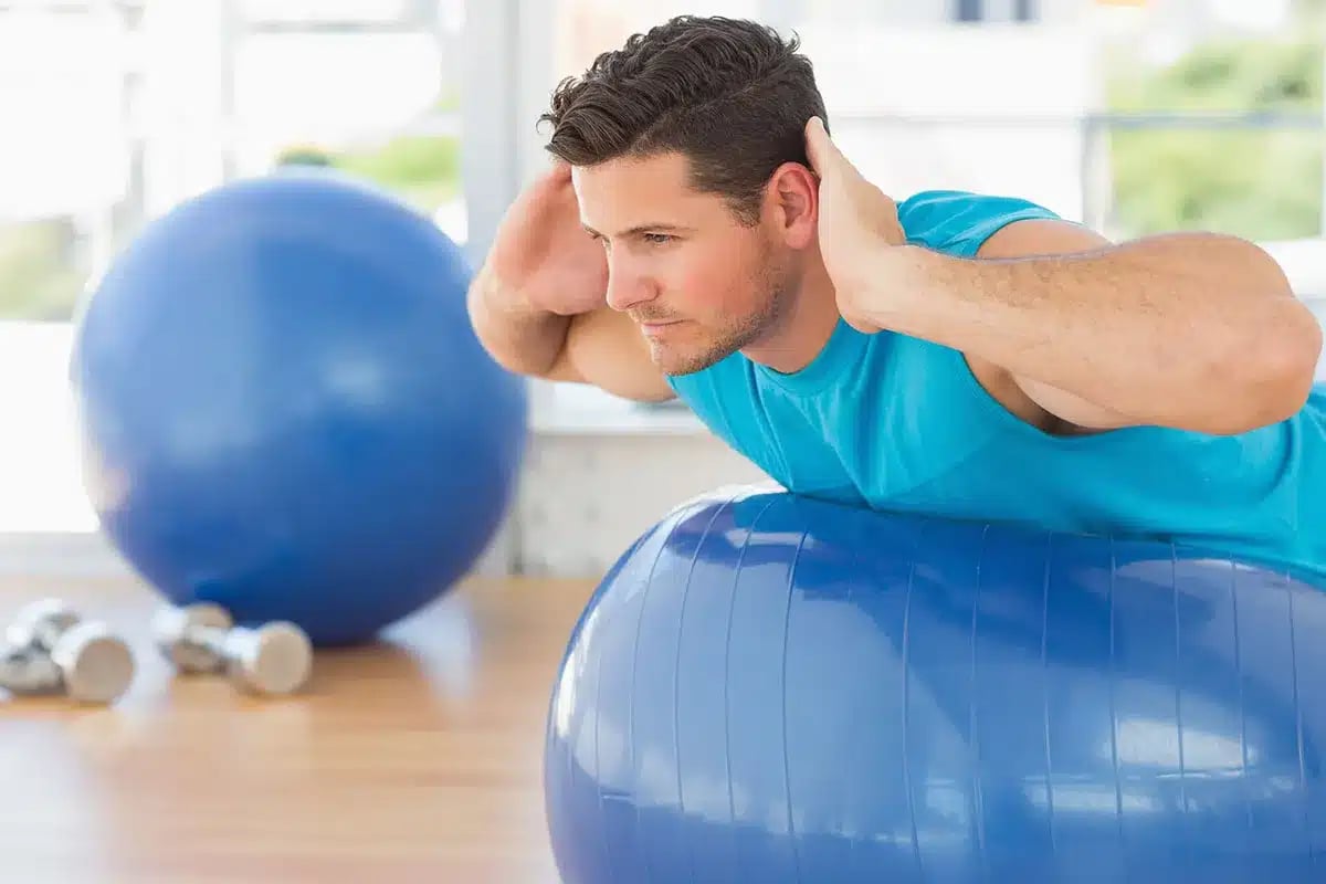 Man doing exercise ball workout.