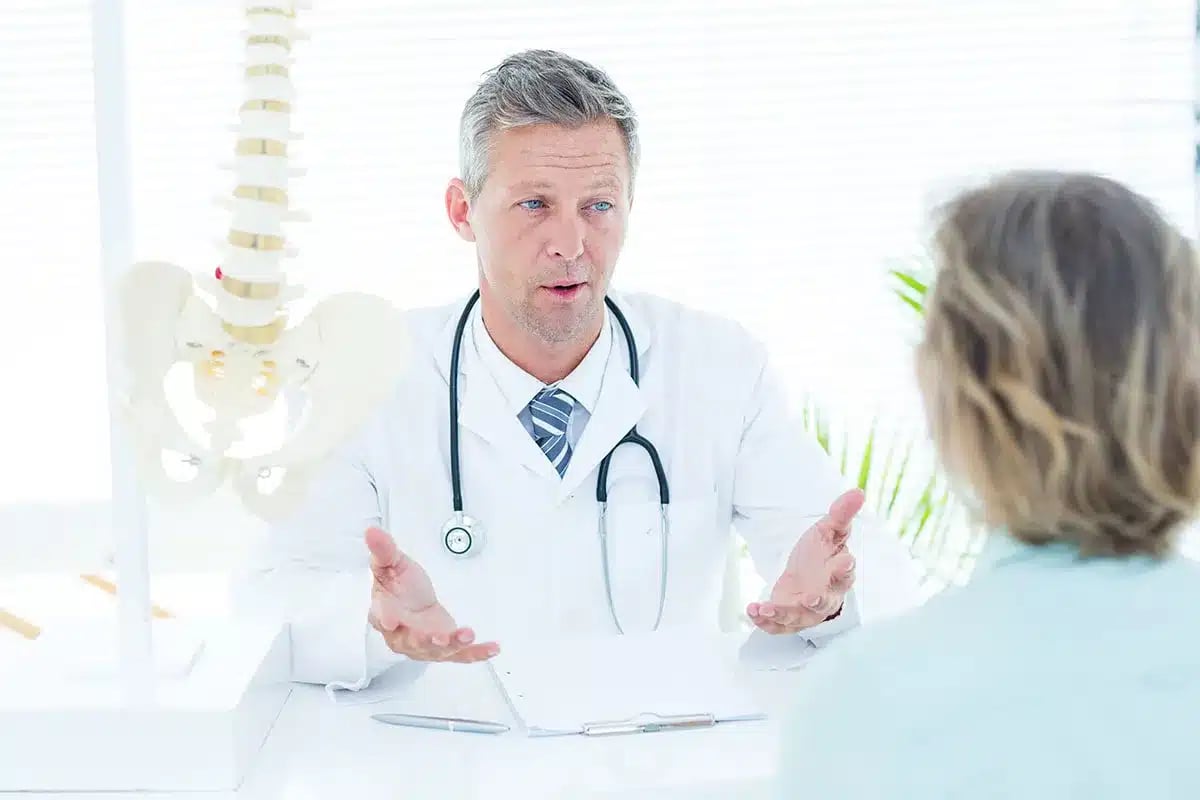 Doctor and elderly patient discussing health.