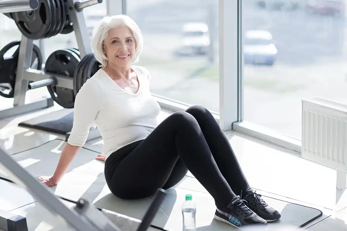 Smiling senior woman resting at the gym.