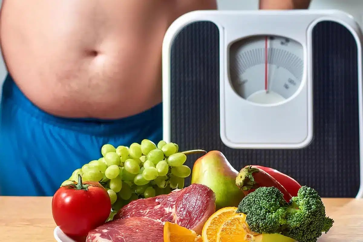 Overweight person with healthy food and scale.