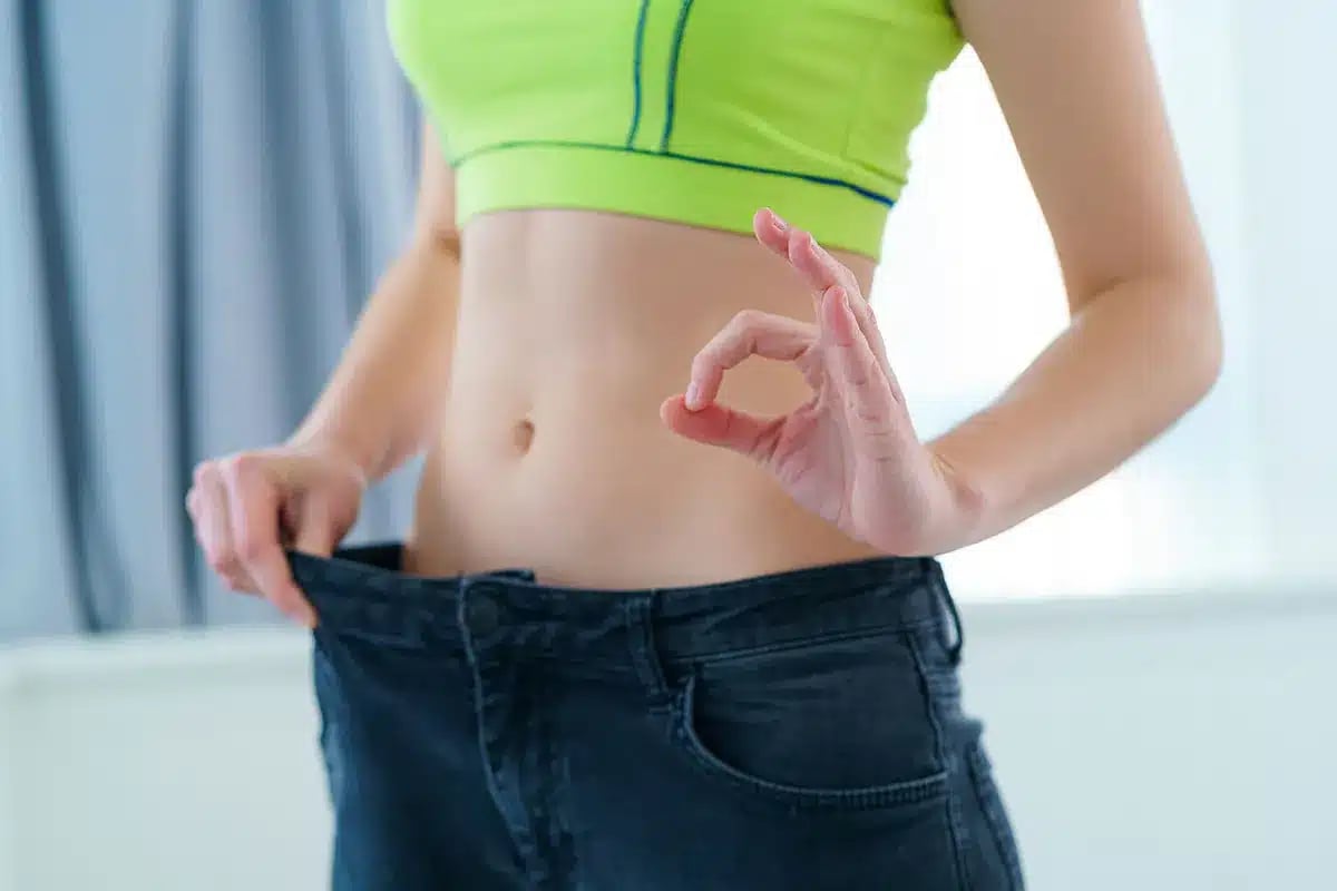 Woman showing weight loss.