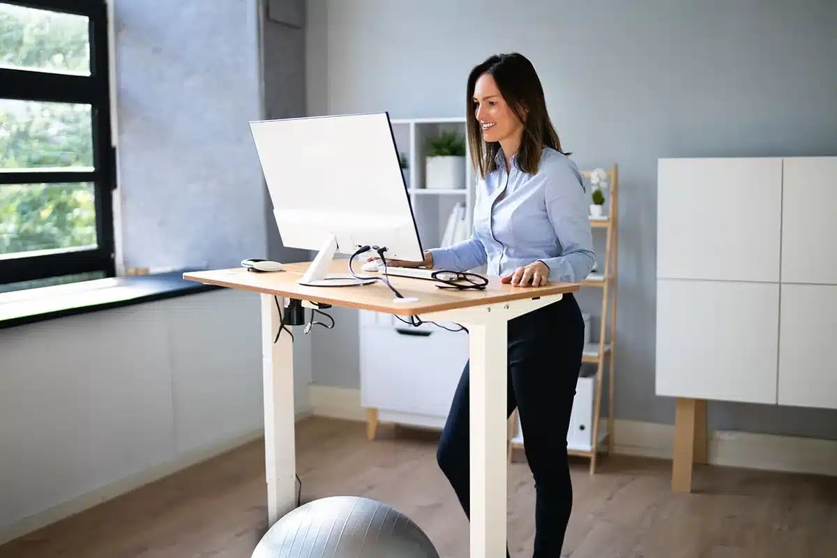 Woman working at standing desk.