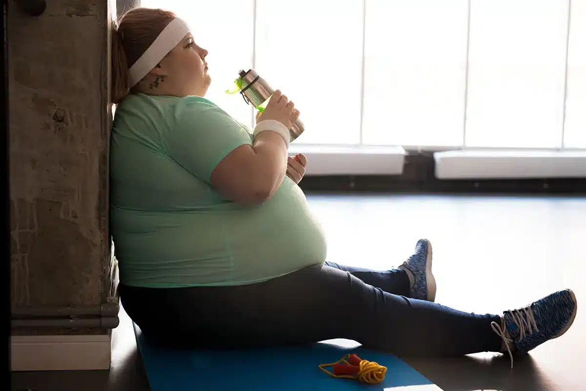 Overweight woman resting after workout.