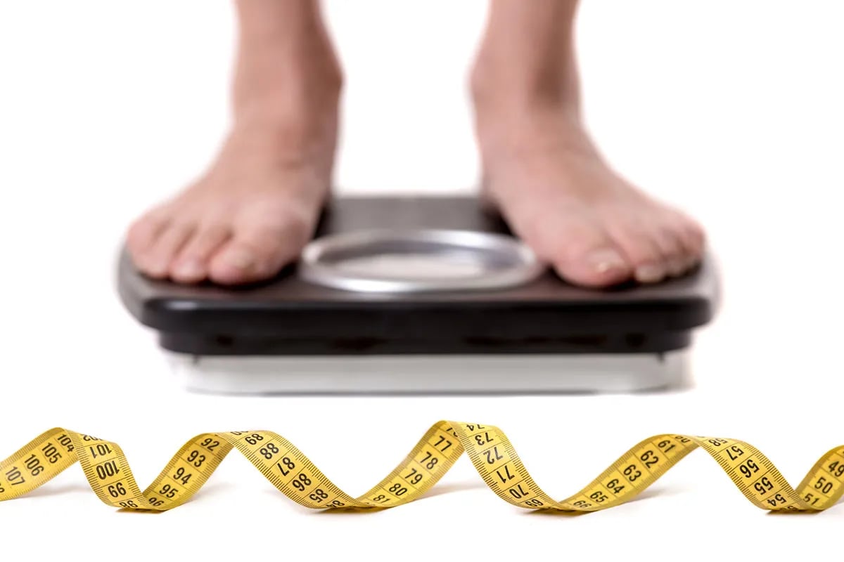 Bathroom scale with measuring tape.