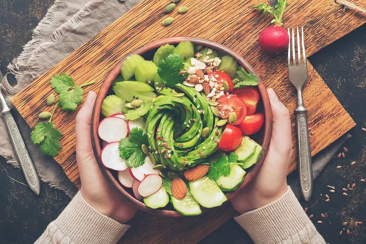 Person holding a healthy avocado bowl.