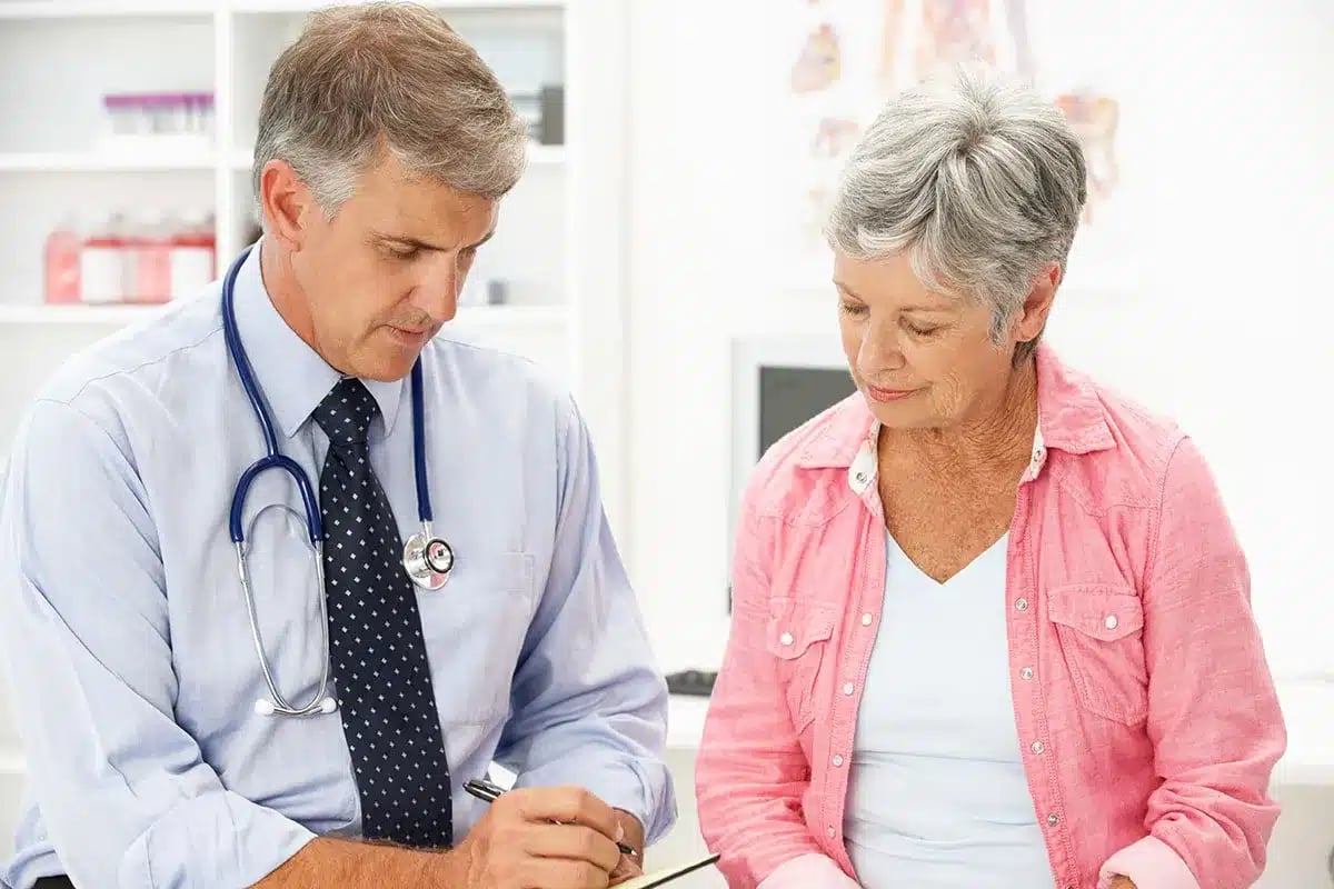 Doctor comforting senior patient.