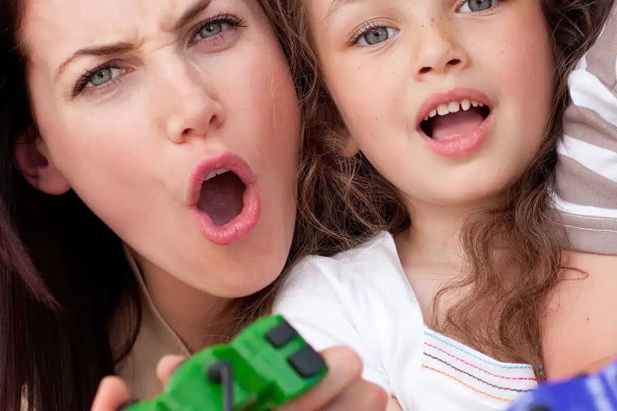 Mother and daughter playing video games.