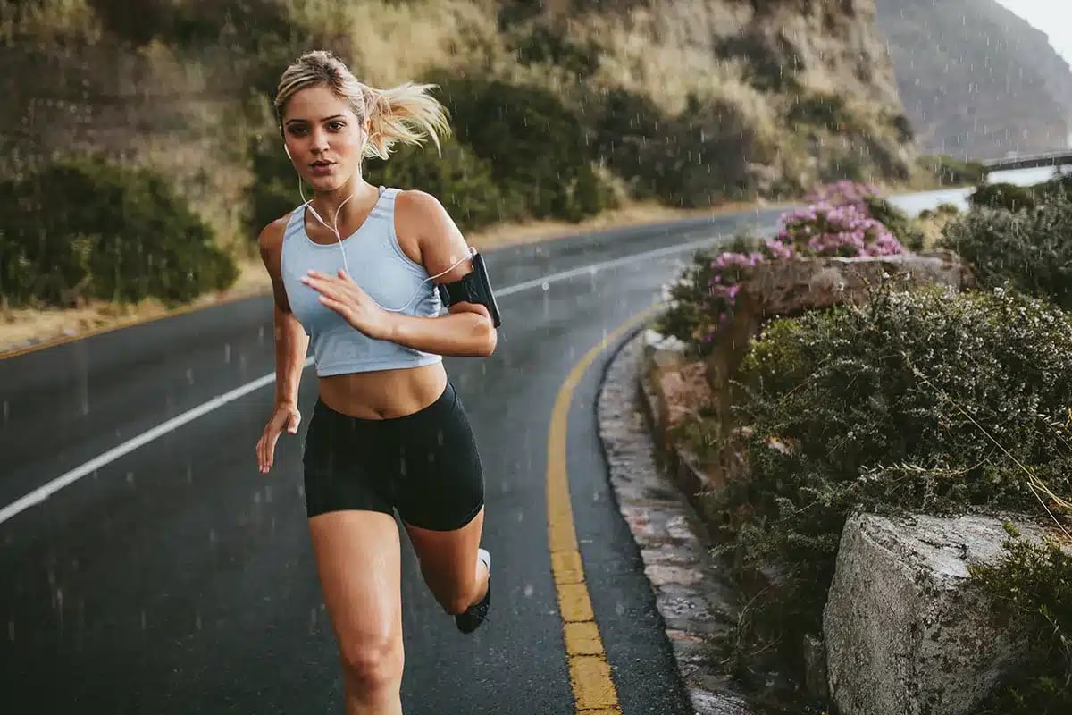 Woman jogging outdoors in the rain.