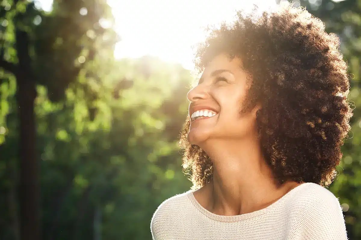Happy woman smiling outdoors.