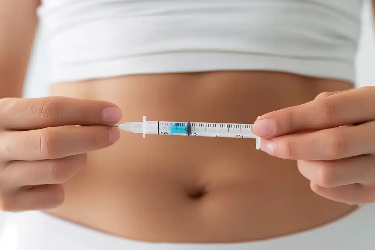 Woman holding a syringe.